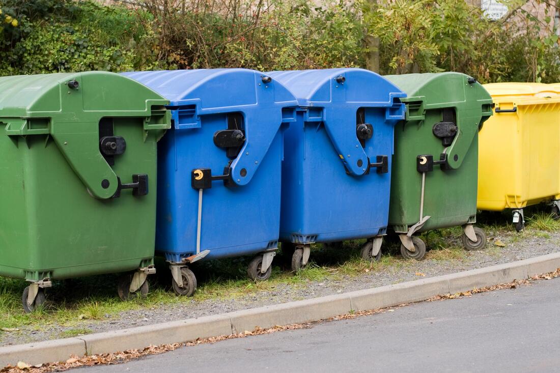 garbage dumpsters near the road