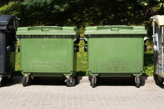 two dumpsters with wheels